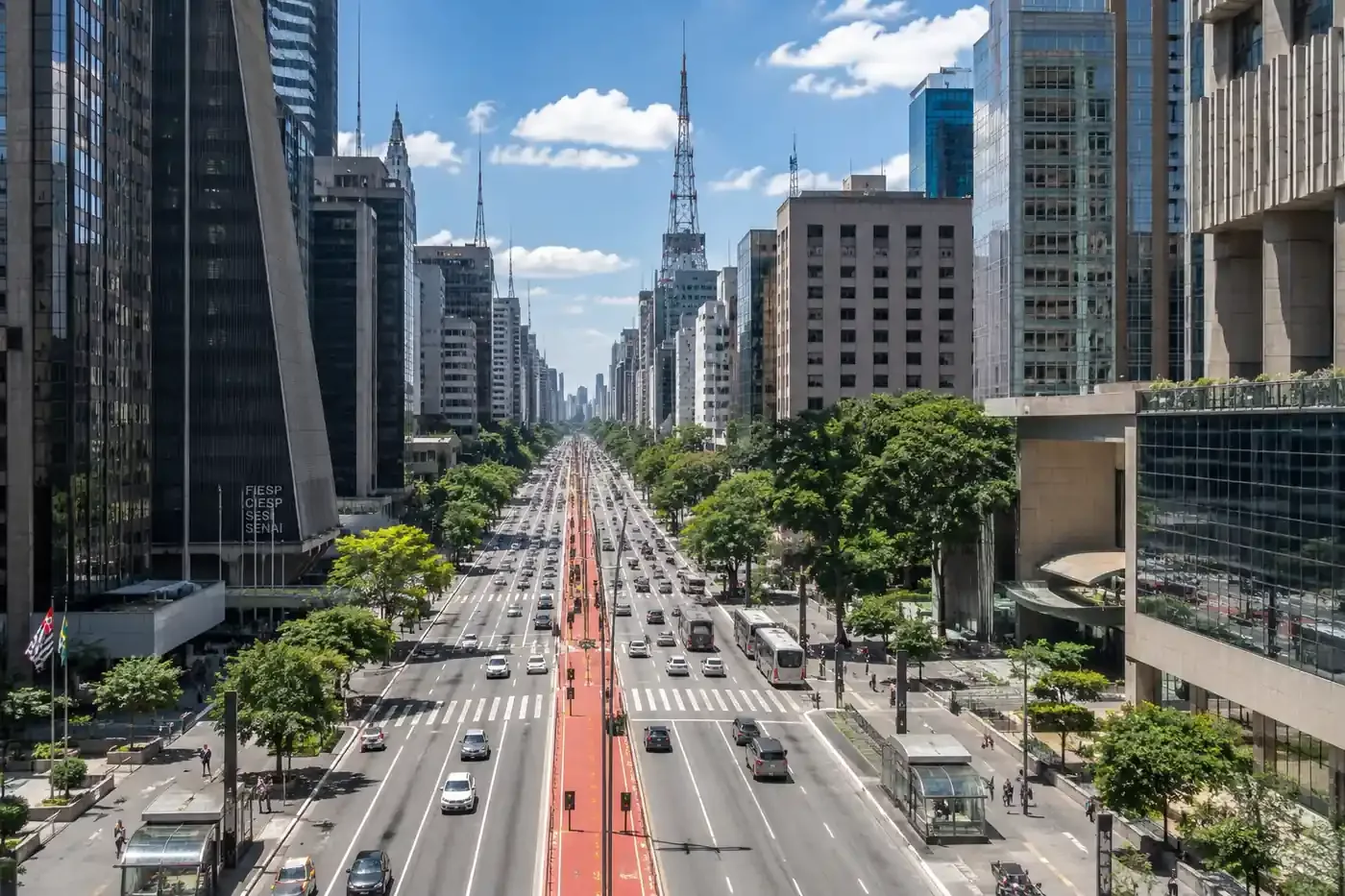 Aerial view of Avenida Paulista in São Paulo with office towers and the red bike lane in the middle